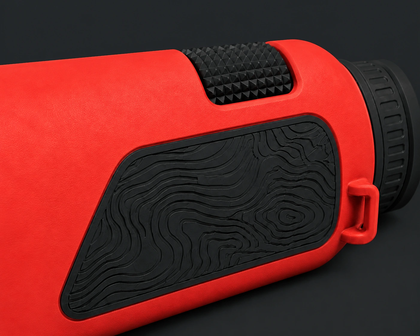 Macro view of the Coral Caldera body showing the black topographic grip panel and diamond-knurled focus wheel